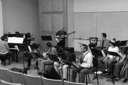 The Jazz Repertory Band rehearsing under direction of Denson Angulo shown playing the bass guitar.